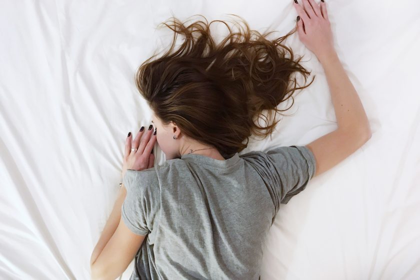 Woman laying face down on bed
