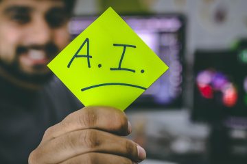 Man holding post it note with A.I written on it.